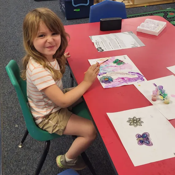 Kid at art table