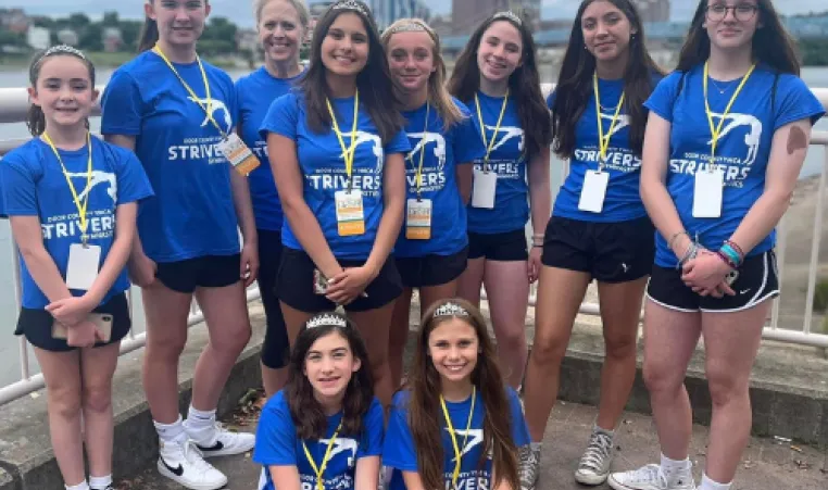 Members of the Strivers gymnastics team poses outside at their national competition.