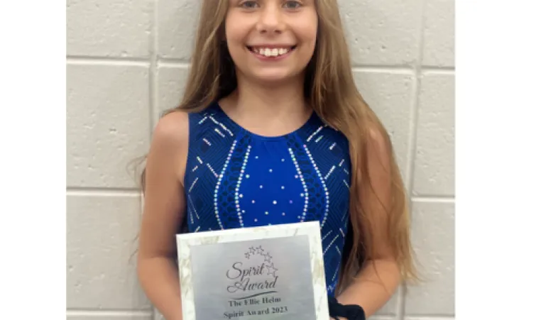 Striver gymnast Shaylyn Asher poses with the Ellie Helm Spirit Award plaque.