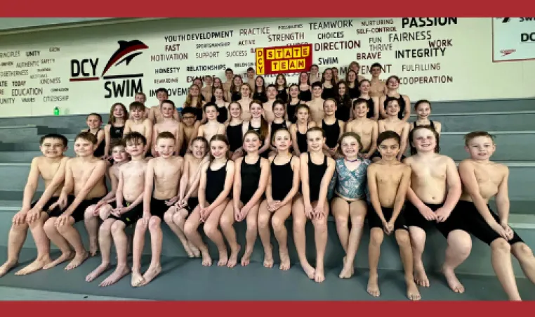 Members of the DCY swim team that recently competed at the state meet pose on the mezzanine.