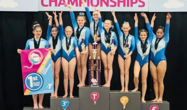 A group of Strivers gymnasts pose on the podium at the state meet