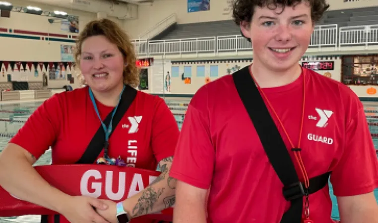 Two smiling lifeguards face the camera